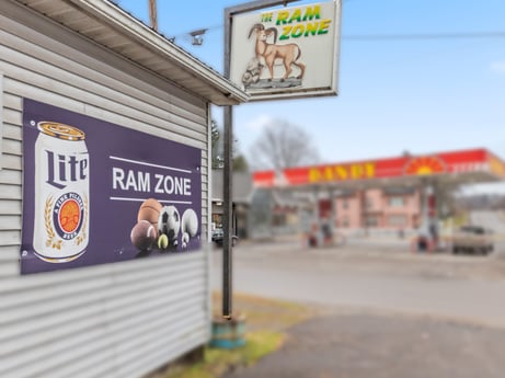 An image featuring sky, building, yellow, gas, font, signage, advertising, city, facade, sign at 199 State St.