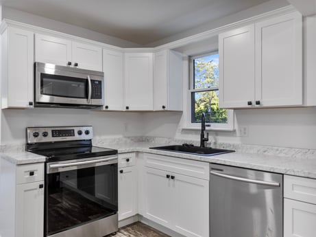 A kitchen at 127 Shore Dr featuring: cabinetry, countertop, property, building, product, kitchen stove, kitchen sink, kitchen, window, sink