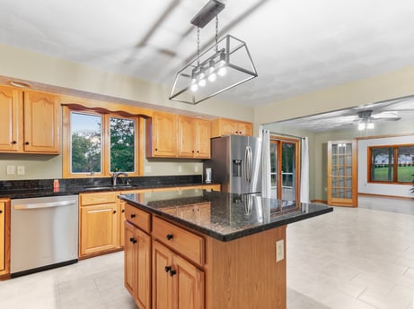 A kitchen at 74 Susquehannock Trail featuring: cabinetry, countertop, property, wood, building, kitchen appliance, lighting, kitchen, kitchen stove, interior design