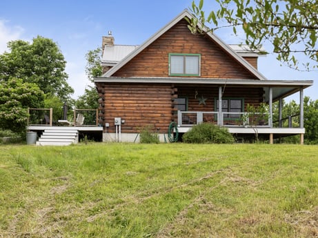 An image featuring sky, plant, building, window, tree, wood, natural landscape, land lot, house, cloud at 1761 Brick House Rd.