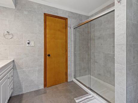An image featuring door, fixture, bathroom, cabinetry, wood, building, automotive exterior, floor, flooring, tile flooring at 125 Rimstone Ct.