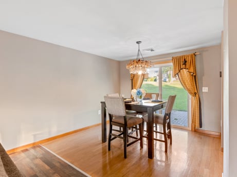 An image featuring table, furniture, chair, wood, interior design, floor, flooring, wood stain, living room, hardwood at 491 Hillcrest Dr.