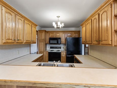 A kitchen at 815 Lakeside Dr featuring: countertop, cabinetry, furniture, property, wood, home appliance, kitchen, kitchen stove, interior design, architecture