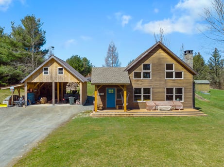 An image featuring sky, cloud, building, window, plant, tree, house, land lot, siding, landscape at 144 Milton Ln.