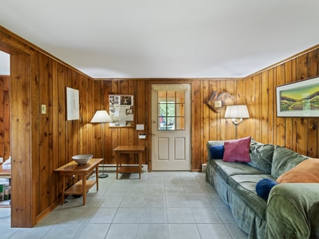 An image featuring building, furniture, picture frame, table, wood, cabinetry, drawer, house, comfort, floor at 130 Haighs Pond Rd.