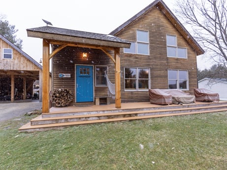 An image featuring window, sky, plant, building, wood, land lot, house, tree, siding, landscape at 144 Milton Ln.