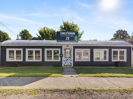 An image featuring sky, window, plant, cloud, tree, door, rural area, facade, gas, grass at 302 N Keystone Ave.