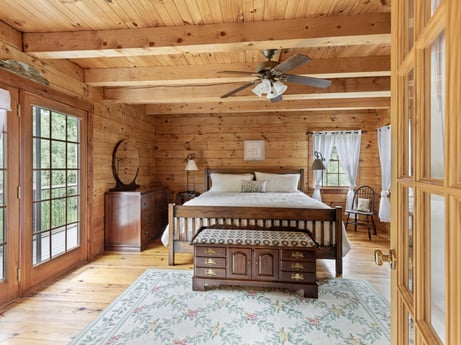 An image featuring window, wood, interior design, ceiling fan, flooring, floor, wood stain, beam, table, drawer at 1761 Brick House Rd.
