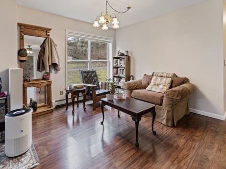 An image featuring couch, table, comfort, wood, lighting, interior design, studio couch, flooring, living room, floor at 1841 Lynch Rd.