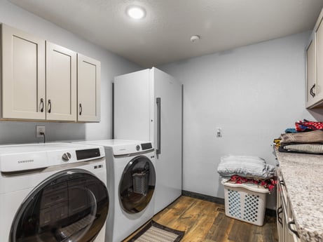 A kitchen at 17899 US-6 featuring: laundry room, clothes dryer, washing machine, cabinetry, kitchen appliance, home appliance, interior design, laundry, kitchen, floor