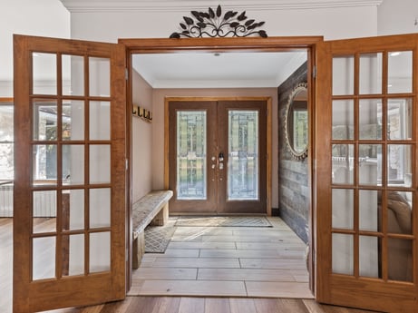 An image featuring door, fixture, wood, interior design, building, wood stain, floor, flooring, hardwood, real estate at 125 Rimstone Ct.