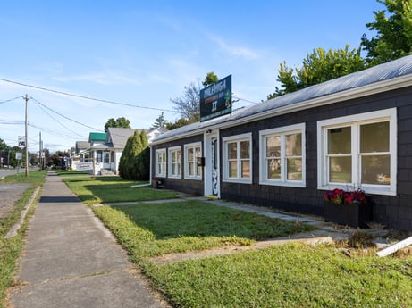 An image featuring sky, cloud, plant, building, window, tree, land lot, grass, road surface, house at 302 N Keystone Ave.
