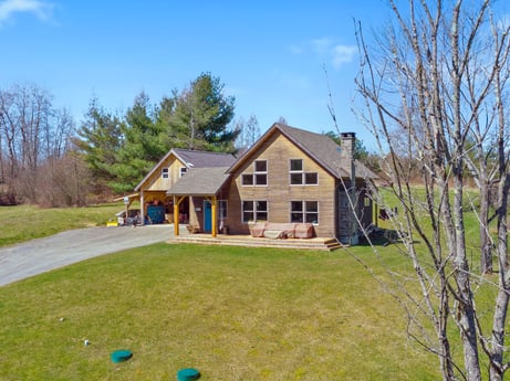 An image featuring sky, plant, cloud, building, window, tree, house, natural landscape, land lot, wood at 144 Milton Ln.