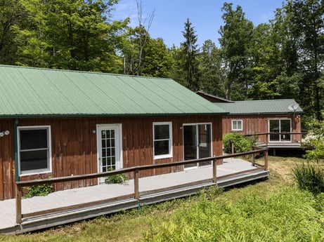 An image featuring plant, window, sky, wood, house, building, tree, land lot, siding, cottage at 154 Fox Run Rd.