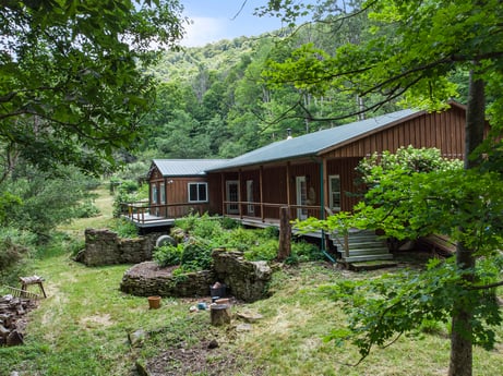 An image featuring plant, building, window, tree, natural landscape, wood, land lot, sky, cottage, house at 154 Fox Run Rd.