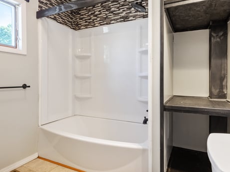 An image featuring bathtub, property, plumbing fixture, wood, shower, interior design, fixture, architecture, bathroom, floor at 132 Wilbur St.