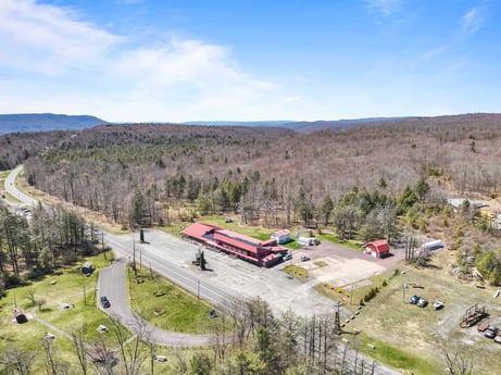 An image featuring cloud, sky, plant, ecoregion, vehicle, tree, land lot, slope, natural landscape, landscape at 4741 US-220.