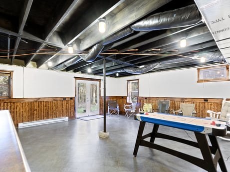 An image featuring table, wood, hall, interior design, flooring, floor, hardwood, ceiling, space, table tennis racket at 1061 Muncy St.