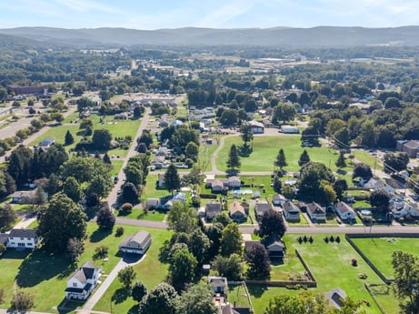 An image featuring sky, daytime, plant, cloud, nature, natural landscape, land lot, tree, urban design, grass at 132 Wilbur St.