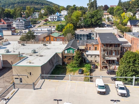 An image featuring building, property, sky, window, plant, tree, infrastructure, car, vehicle, house at 213 Main St.