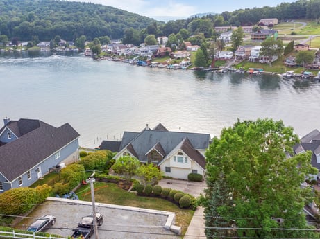 An image featuring water, building, water resources, sky, plant, tree, cloud, house, lake, body of water at 218 Point Rd.