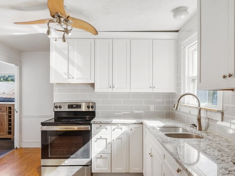 A kitchen at 132 Wilbur St featuring: cabinetry, countertop, kitchen sink, property, sink, white, building, ceiling fan, wood, kitchen