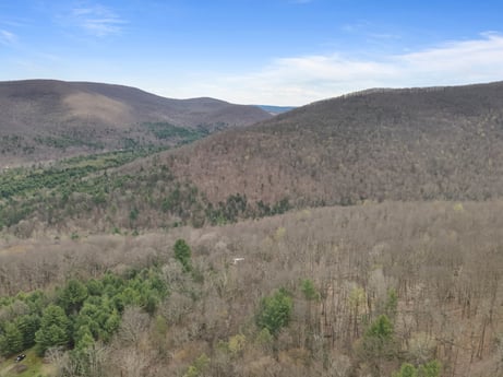 An image featuring cloud, sky, plant, mountain, natural landscape, terrain, grassland, grass, formation, landscape at English Hollow Ln.