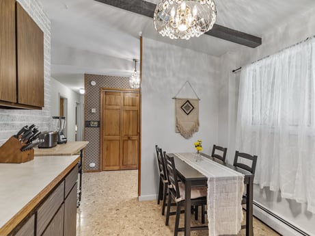 A kitchen at 104 Stony Mountain Rd featuring: furniture, cabinetry, property, table, countertop, chair, wood, kitchen, lighting, interior design