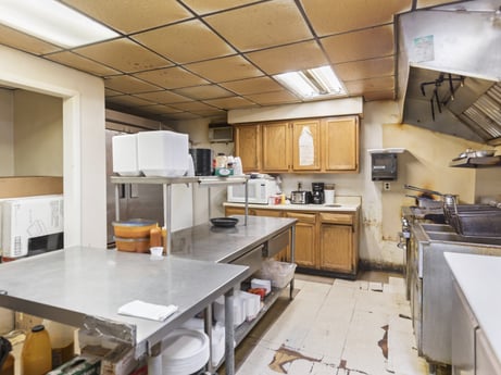 A kitchen at 199 State St featuring: cabinetry, table, furniture, countertop, kitchen, wood, kitchen stove, kitchen appliance, building, chair