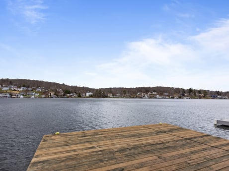 An image featuring water, sky, cloud, sunlight, lake, wood, natural landscape, tree, horizon, landscape at 815 Lakeside Dr.