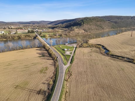 An image featuring water, sky, water resources, cloud, plant, natural landscape, road surface, tree, land lot, asphalt at River Access Rd.
