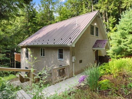 An image featuring plant, building, window, plant community, house, tree, wood, cottage, land lot, natural landscape at 459 Pine Hill Dr.