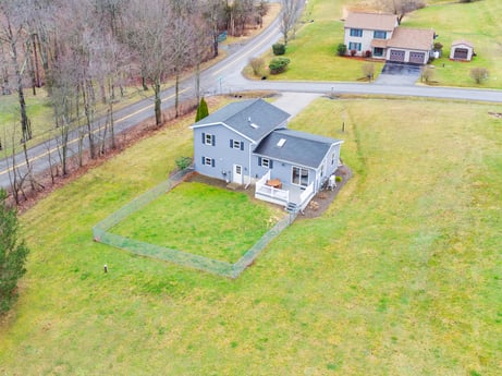 An image featuring building, plant, house, window, land lot, slope, grassland, tree, landscape, grass at 18 Country View Dr.