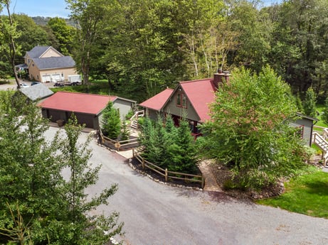 An image featuring plant, property, window, building, tree, house, land lot, vegetation, cottage, residential area at 276 Mountain View Ln.