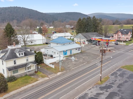 An image featuring sky, building, plant, window, tree, mountain, house, road surface, land lot, cloud at 199 State St.