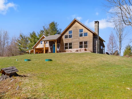 An image featuring sky, cloud, building, property, window, plant, natural landscape, tree, land lot, house at 144 Milton Ln.