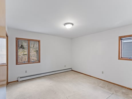 An image featuring window, building, fixture, wood, paint, floor, hall, flooring, real estate, picture frame at 815 Lakeside Dr.