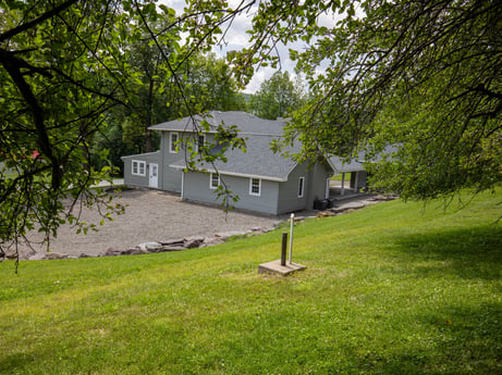 An image featuring plant, building, property, window, house, tree, land lot, grass, cottage, rural area at 17899 US-6.