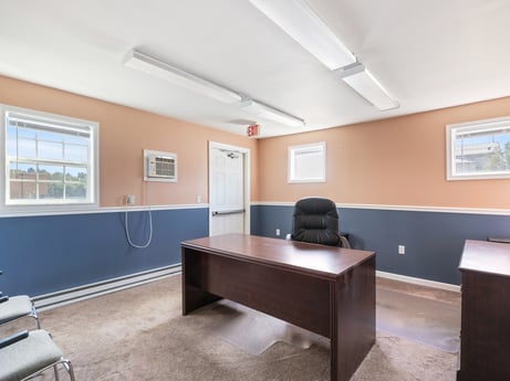 An image featuring property, table, interior design, lighting, floor, flooring, window, desk, city, ceiling at 213 Main St.