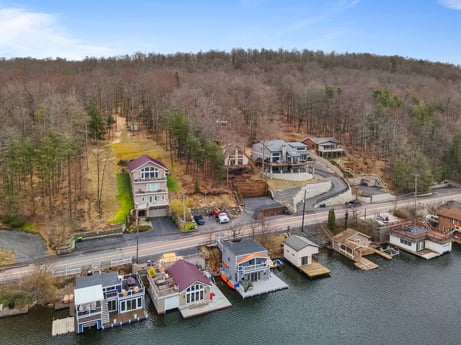 An image featuring sky, water, plant, cloud, vehicle, building, tree, watercraft, urban design, house at 815 Lakeside Dr.