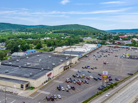 An image featuring sky, daytime, cloud, urban design, tree, thoroughfare, asphalt, residential area, road surface, city at 1040 Center St.