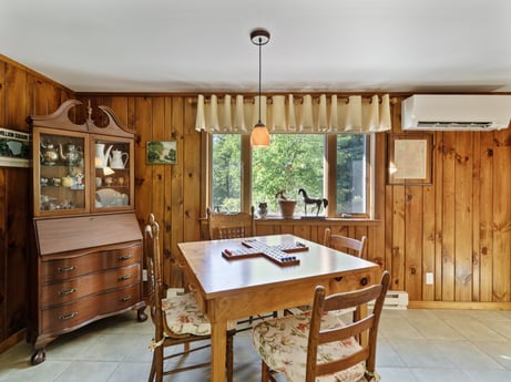 An image featuring furniture, table, cabinetry, property, window, chair, wood, interior design, wood stain, floor at 130 Haighs Pond Rd.