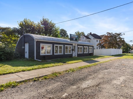 An image featuring sky, plant, cloud, building, property, window, tree, house, land lot, asphalt at 302 N Keystone Ave.