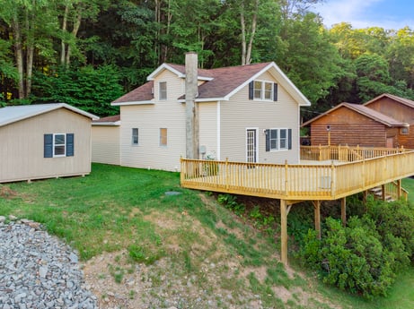 An image featuring property, plant, building, window, sky, wood, house, land lot, tree, slope at 127 Shore Dr.