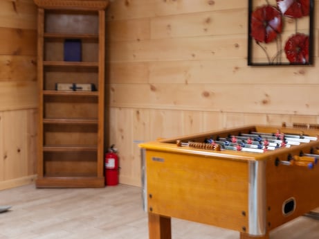 An image featuring property, wood, flooring, floor, indoor games and sports, wood stain, hardwood, recreation room, varnish, building at 125 Rimstone Ct.