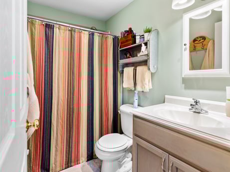 An image featuring mirror, sink, shower curtain, property, plumbing fixture, bathroom cabinet, tap, green, bathroom, purple at 459 Pine Hill Dr.