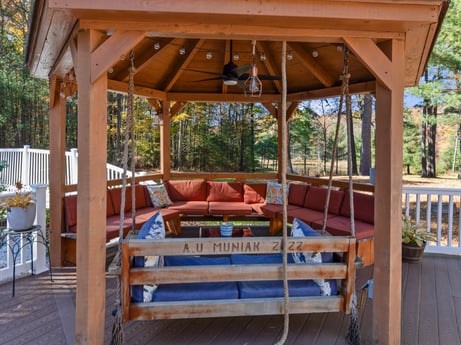 An image featuring shade, wood, plant, outdoor furniture, tree, wood stain, leisure, hardwood, landscape, outdoor structure at 125 Rimstone Ct.