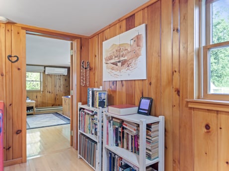 An image featuring window, furniture, building, wood, cabinetry, shelf, interior design, bookcase, fixture, floor at 130 Haighs Pond Rd.