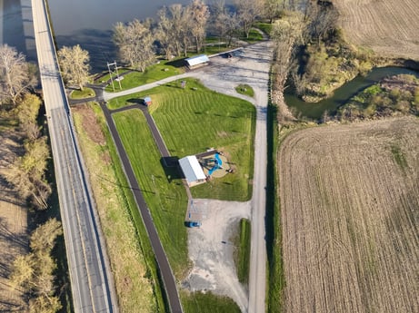 An image featuring plant, tree, slope, land lot, highland, building, grass, urban design, thoroughfare, road at River Access Rd.