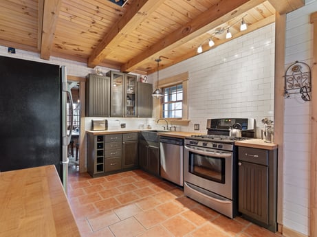 A kitchen at 1761 Brick House Rd featuring: cabinetry, countertop, property, furniture, kitchen stove, sink, kitchen appliance, wood, kitchen, interior design